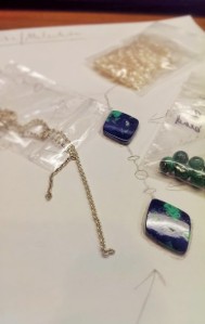 Sample materials, including chain, pearls, and some malachite beads